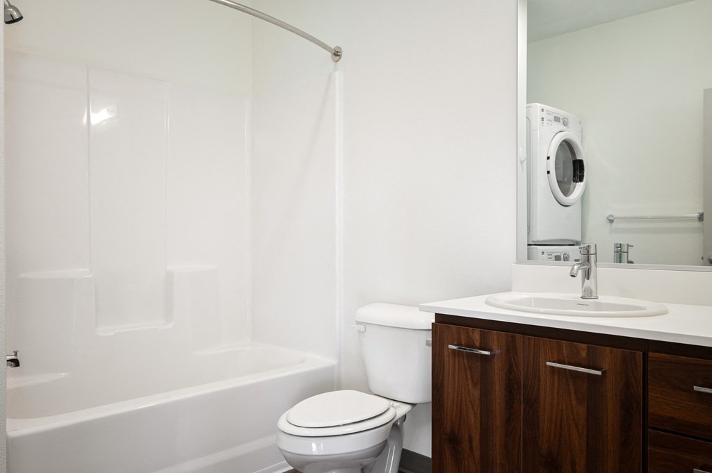 a bathroom with a toilet and a sink and a bath tub