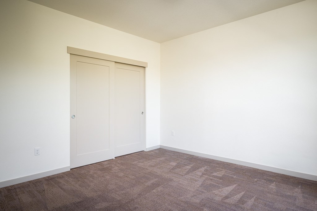 an empty room with white walls and a door