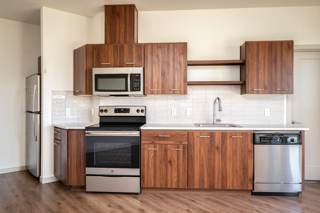 a kitchen with wooden cabinets and stainless steel appliances