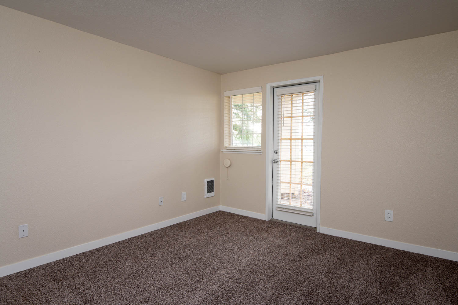 Sundial Apartments | Two Bedroom Primary Bedroom with Wall to Wall Carpet