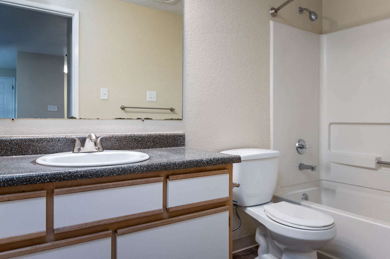 Sundial Apartments | Two Bedroom Bathroom with White Cabinetry