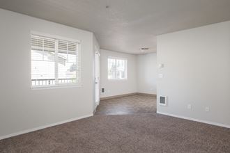 a bedroom with white walls and carpet