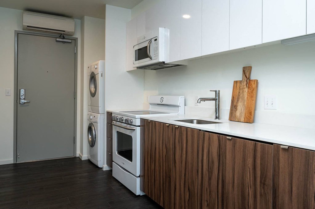 a kitchen with a washer and dryer and a sink