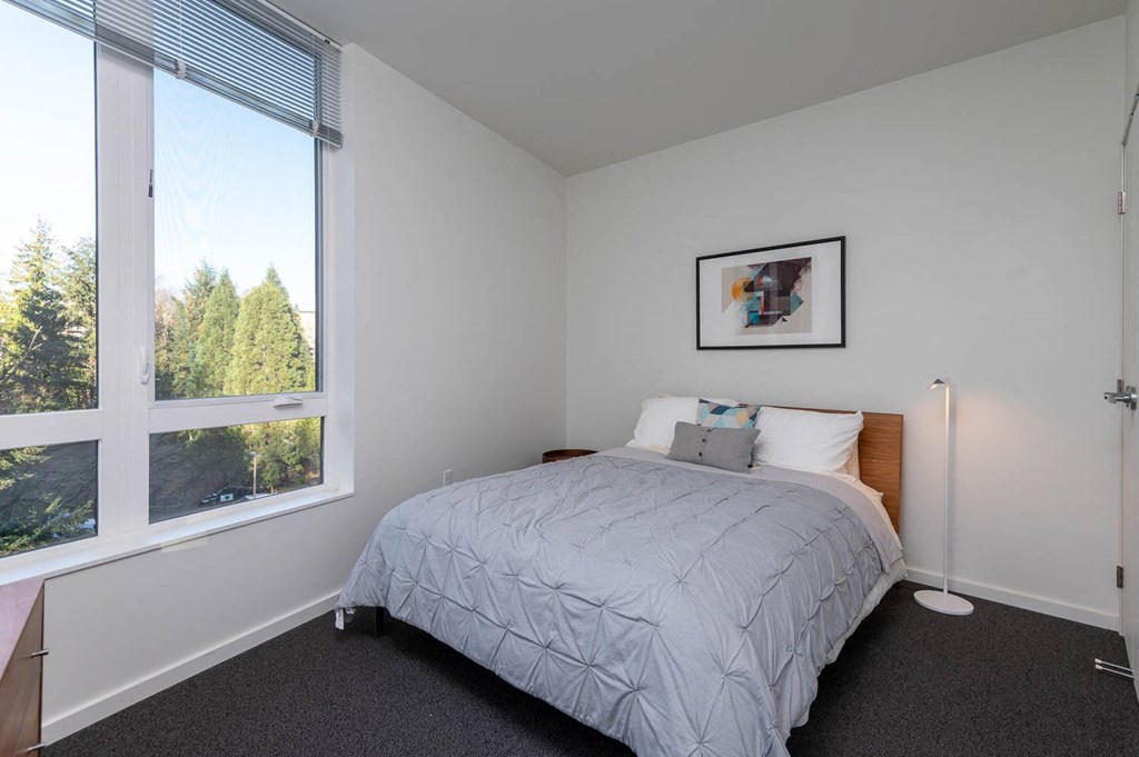 a bedroom with a bed and a wallpaper on the wall