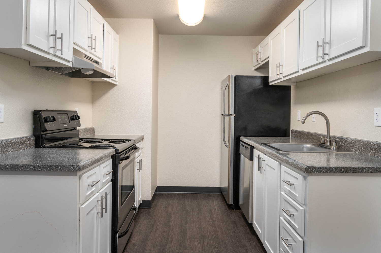 Sundial | Kitchen with White Cabinetry and Plank Flooring