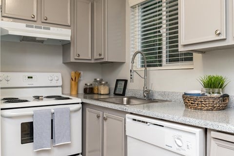 a white kitchen with white appliances and white cabinets