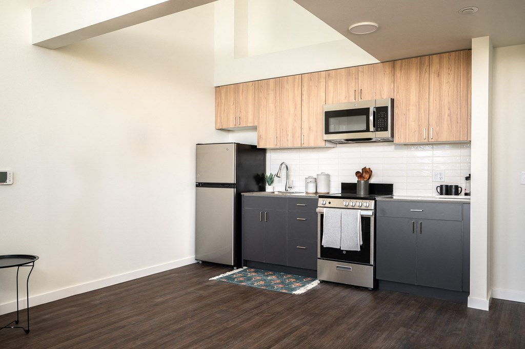 kitchen with stainless steel appliances and two-tone wood cabinetry
