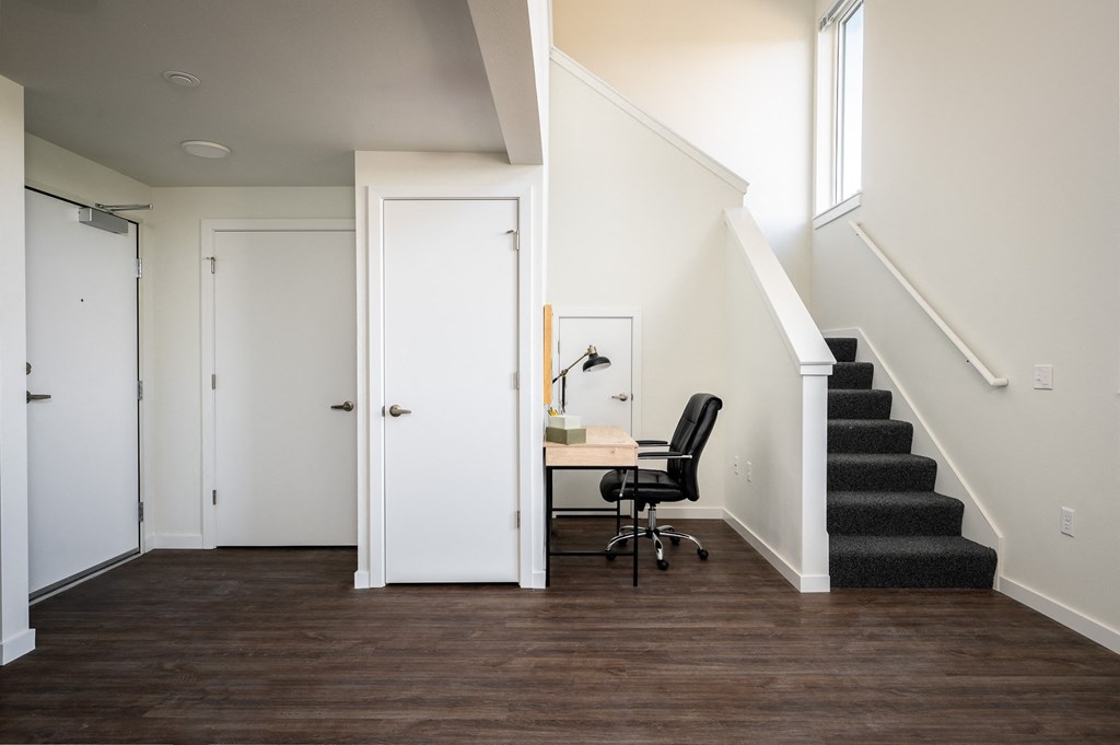 a home office in a home with stairs and a white door