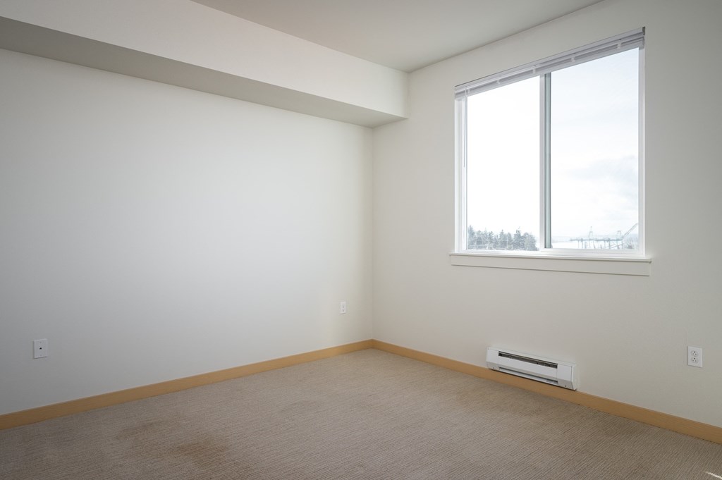 bedroom with large window and carpet