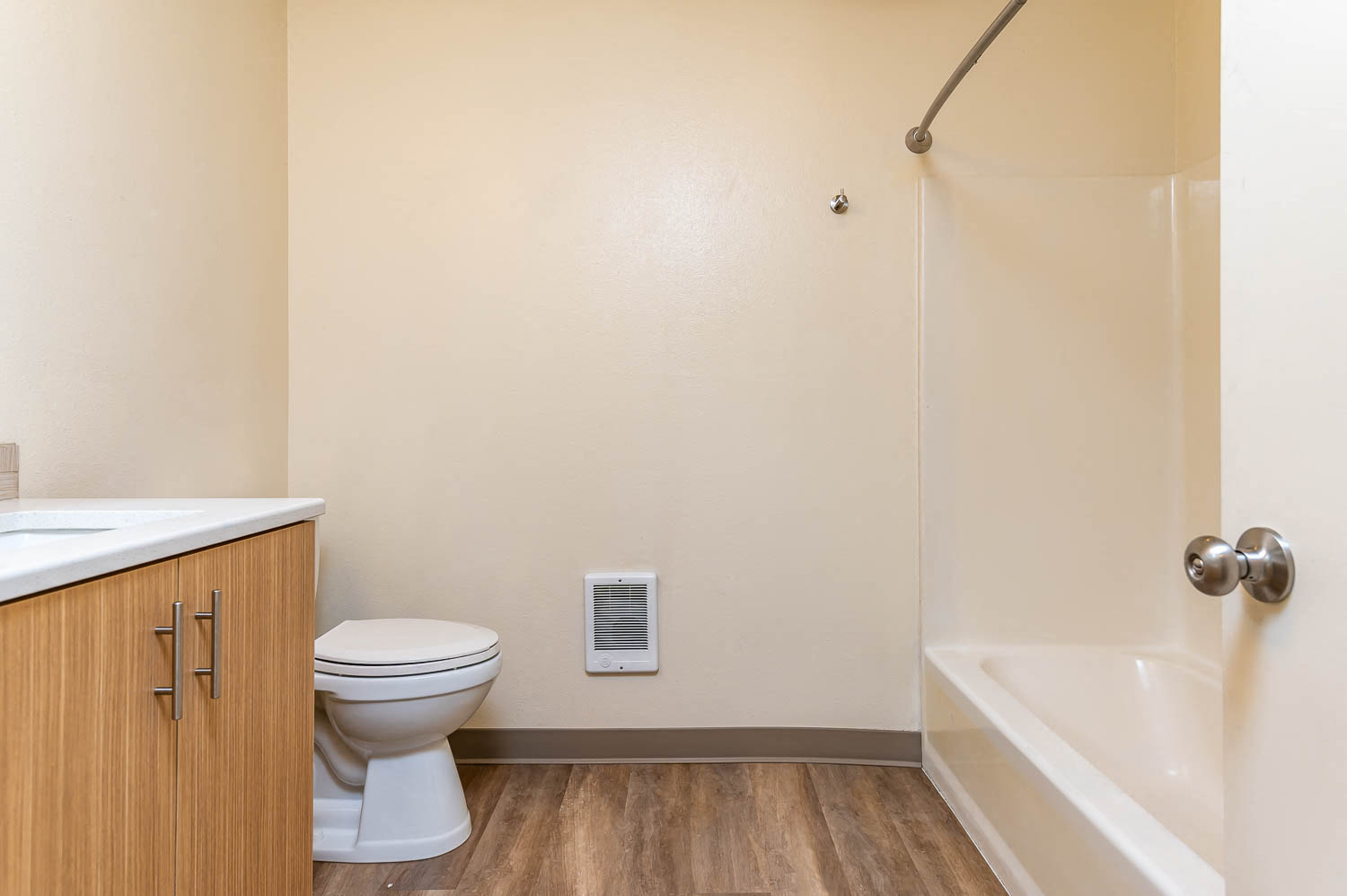 Bathroom with shower, updated flooring and wood cabinetry