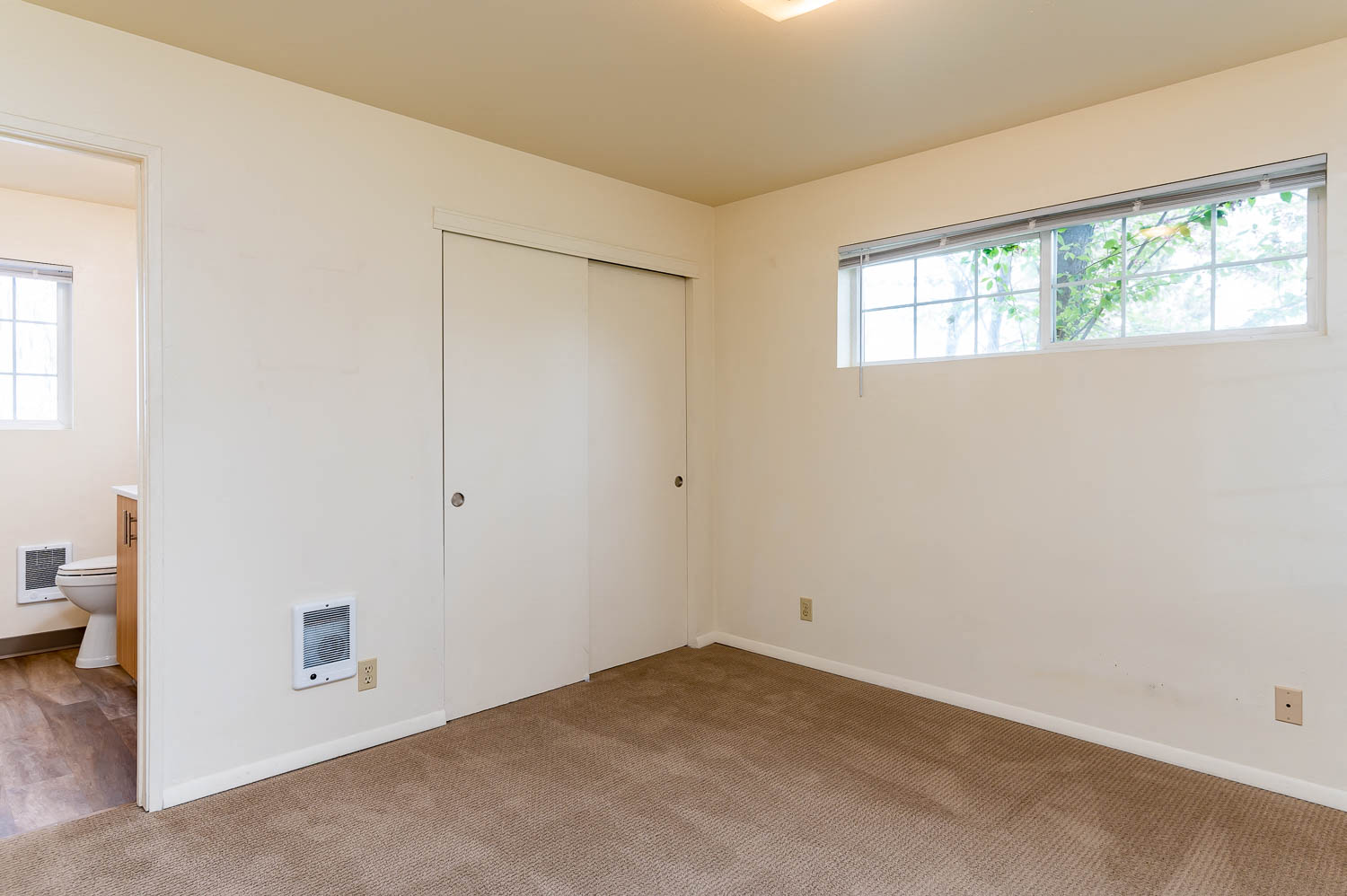 Master Bedroom closet and window, and master bathroom entrance