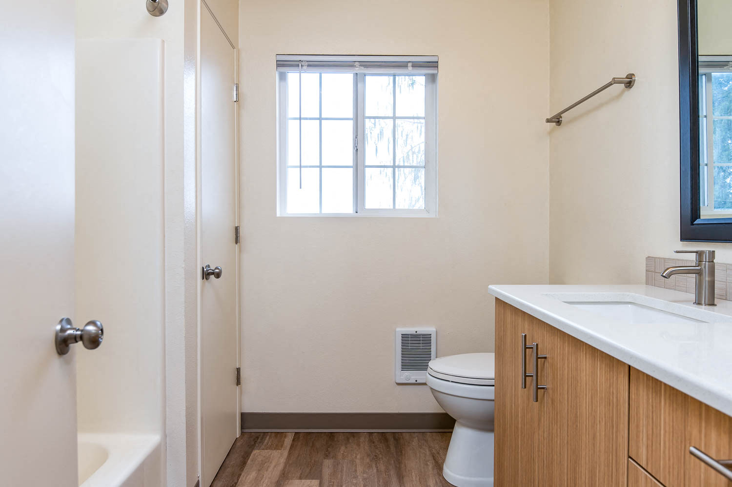 Spacious bathroom with updated hardware, faucet and lighting