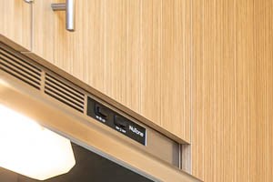 Native Sun | Kitchen Kitchen with stainless steel refrigerator, black stove and wood cabinetry - Photo Gallery 2