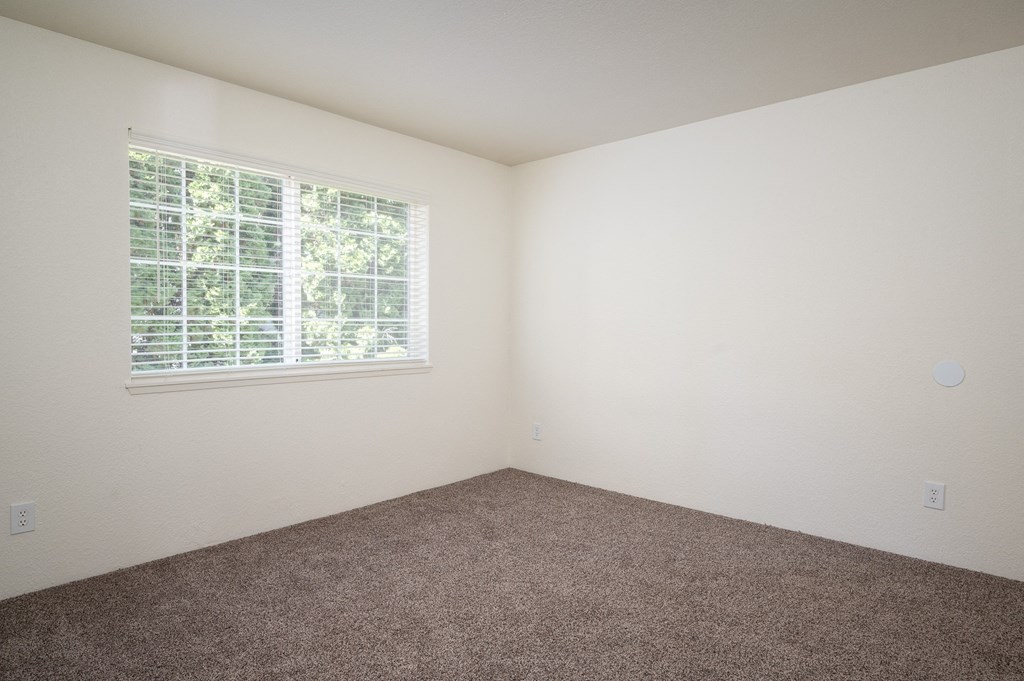 a small empty room with a large window