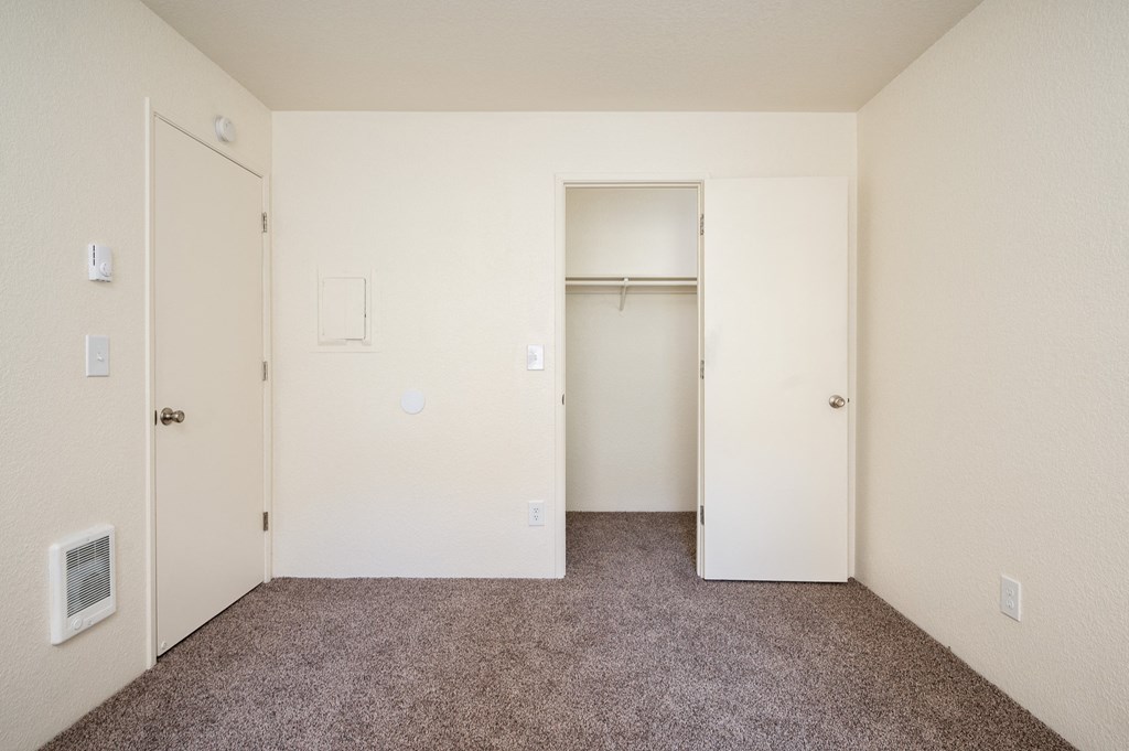 a bedroom with carpeted flooring and white walls
