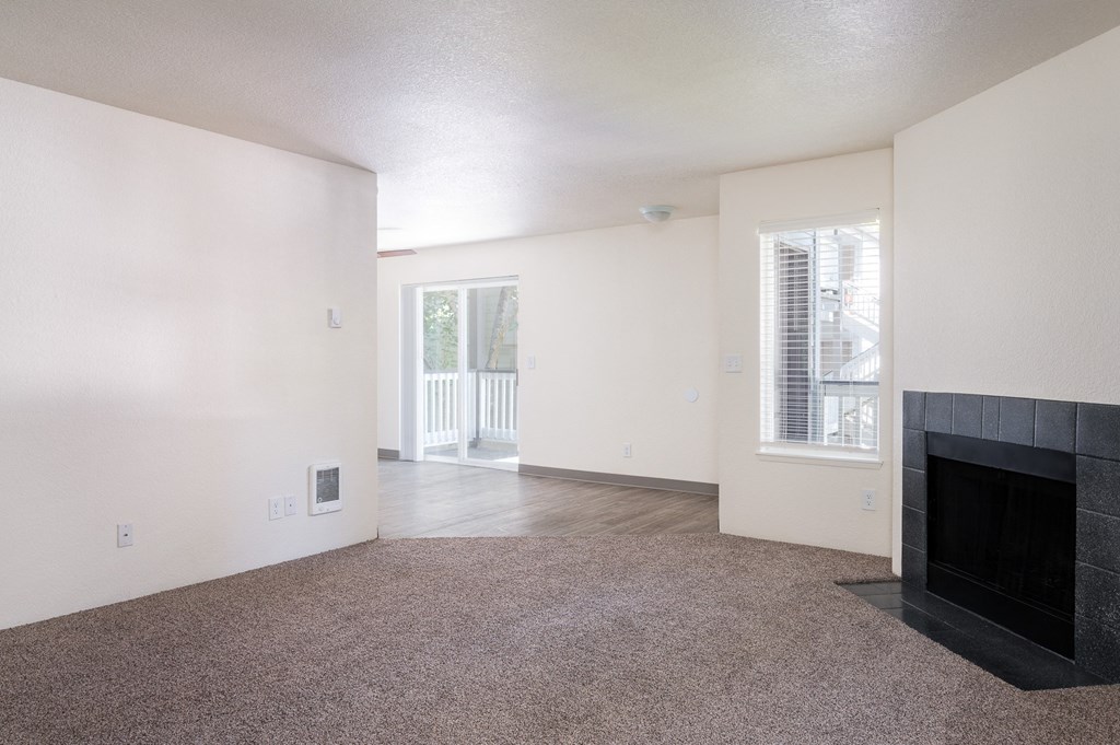 a living room with white walls and a fireplace