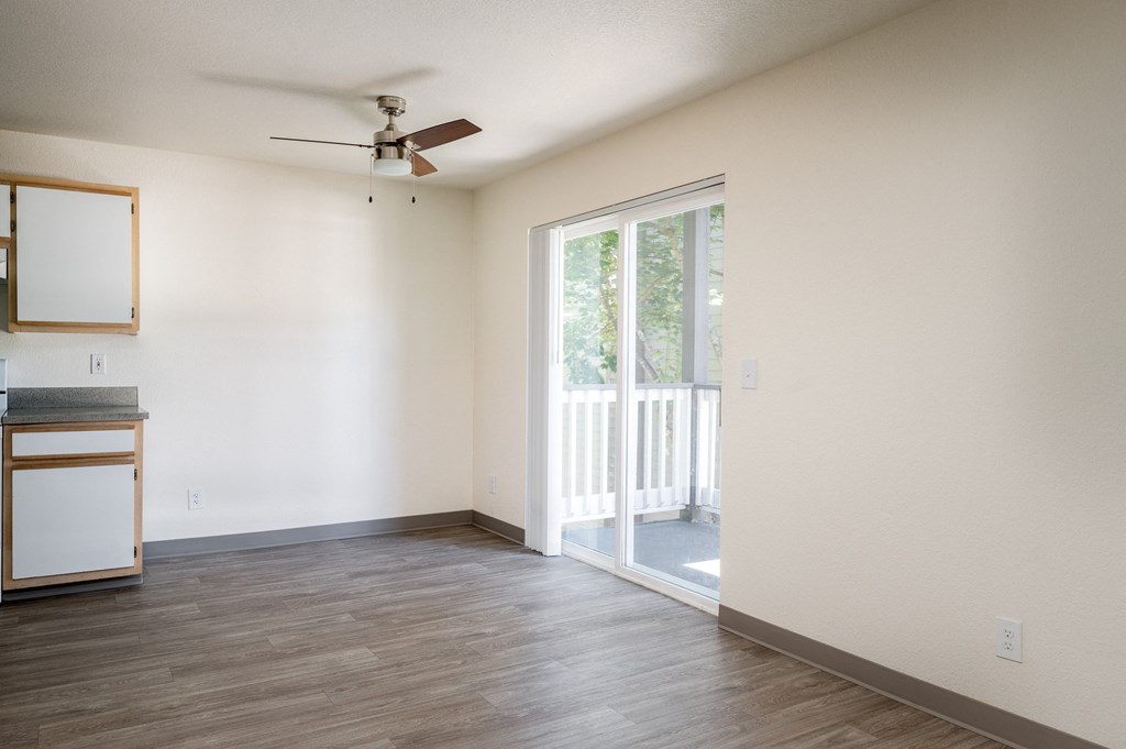 a bedroom with a sliding glass door and a ceiling fan