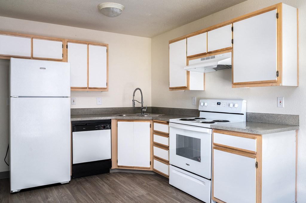 a kitchen with white appliances and wooden cabinets
