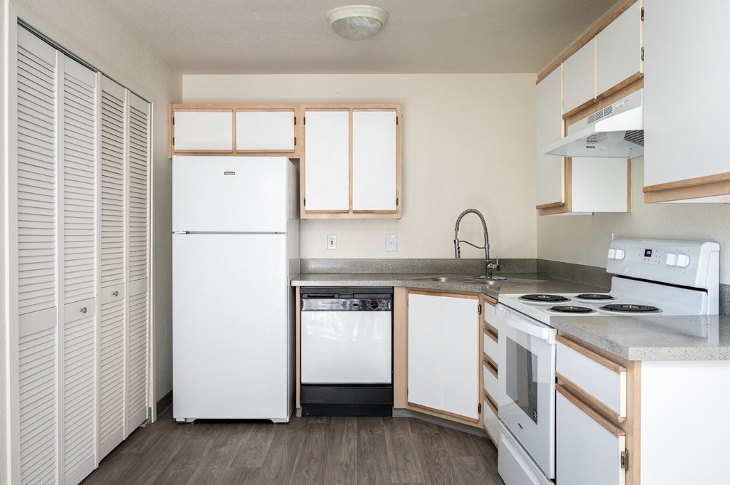 a kitchen with white appliances and white cabinets