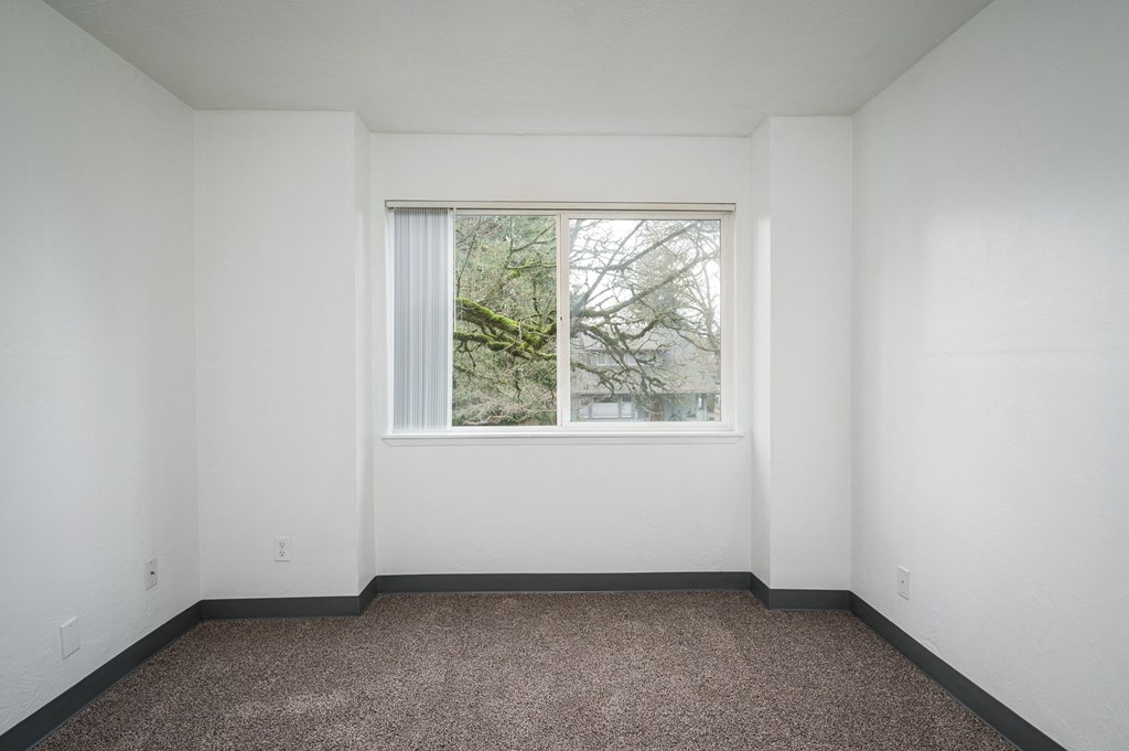 a room with a largeBroadway Center | Bedroom window and a carpet