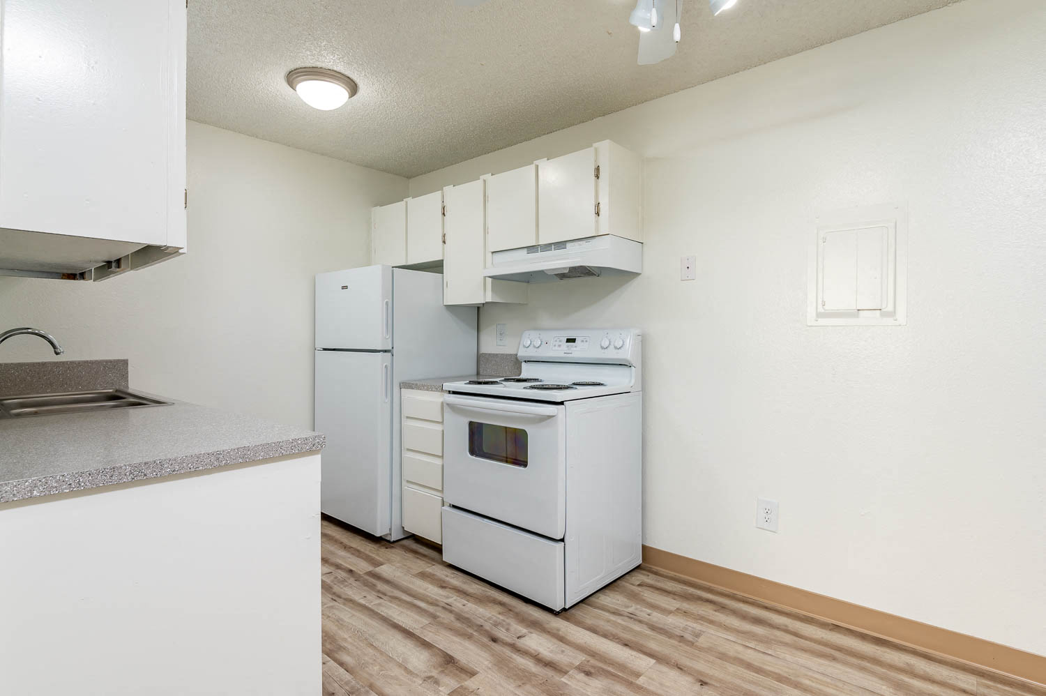a kitchen with white appliances and white cabinets