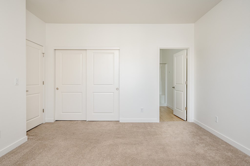 A room with white walls and a carpeted floor.