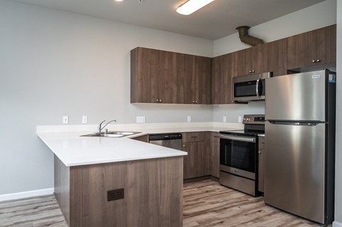 a kitchen with stainless steel appliances and a white counter top