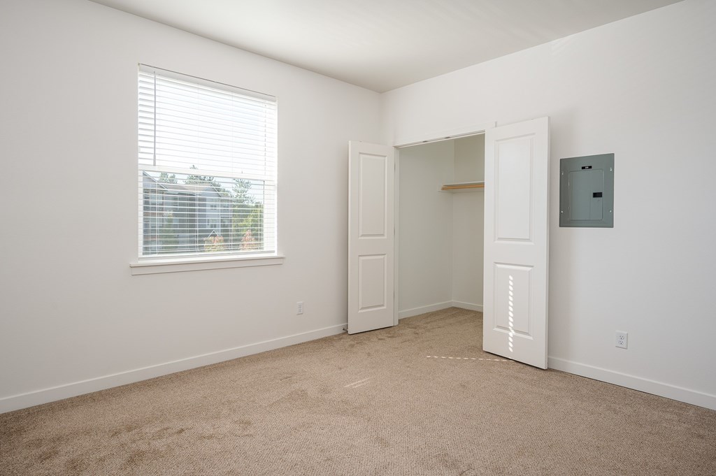 A room with a window and a door.