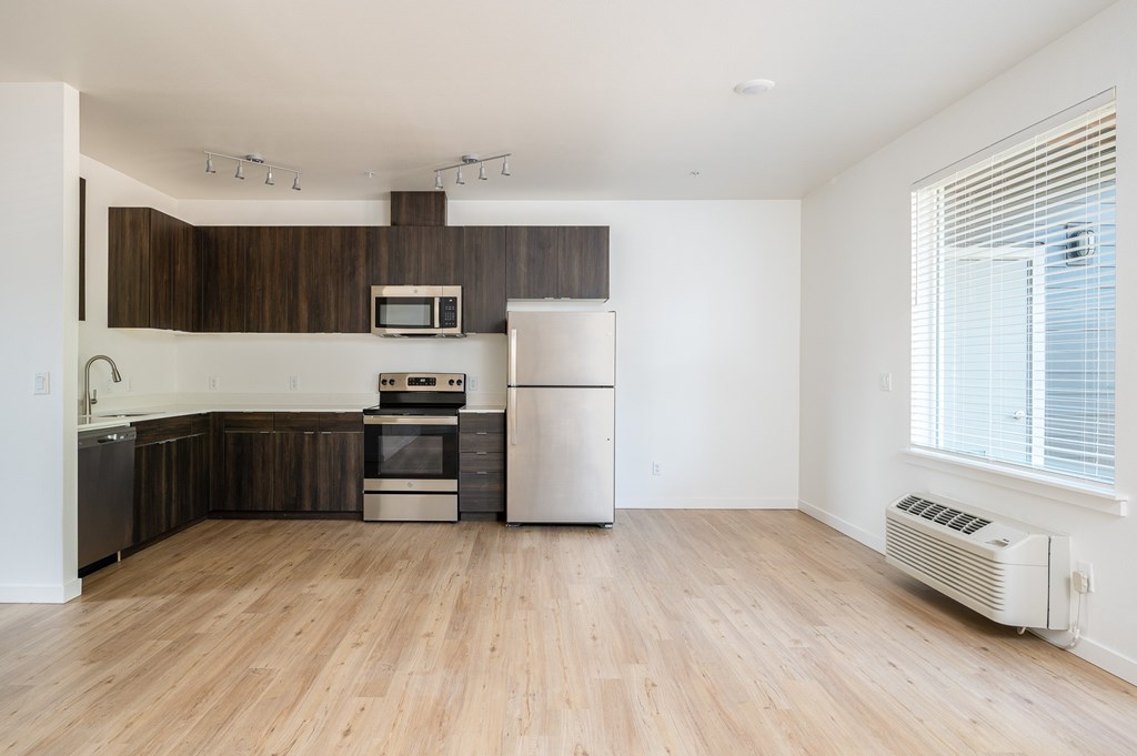 A kitchen with wooden cabinets and a white refrigerator.