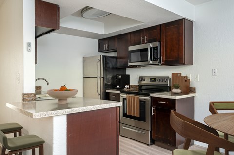 A kitchen with brown cabinets and a white countertop.