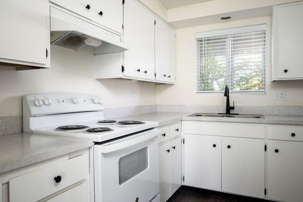 a kitchen with white appliances and white cabinets