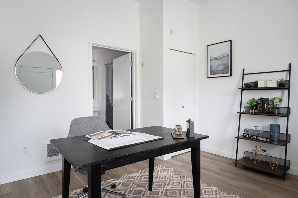 Live work street entry room with a desk and a mirror