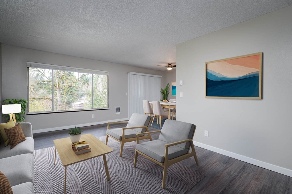 a living room with a couch and chairs and a table
