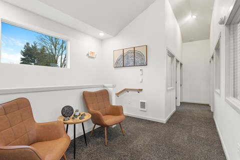 A living room with two chairs and a table.