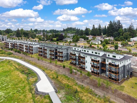 A large apartment complex with a curved walkway in front.