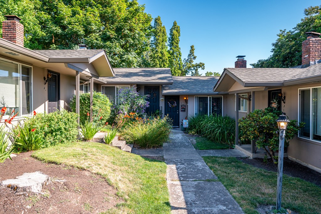 A house with a garden in front of it.