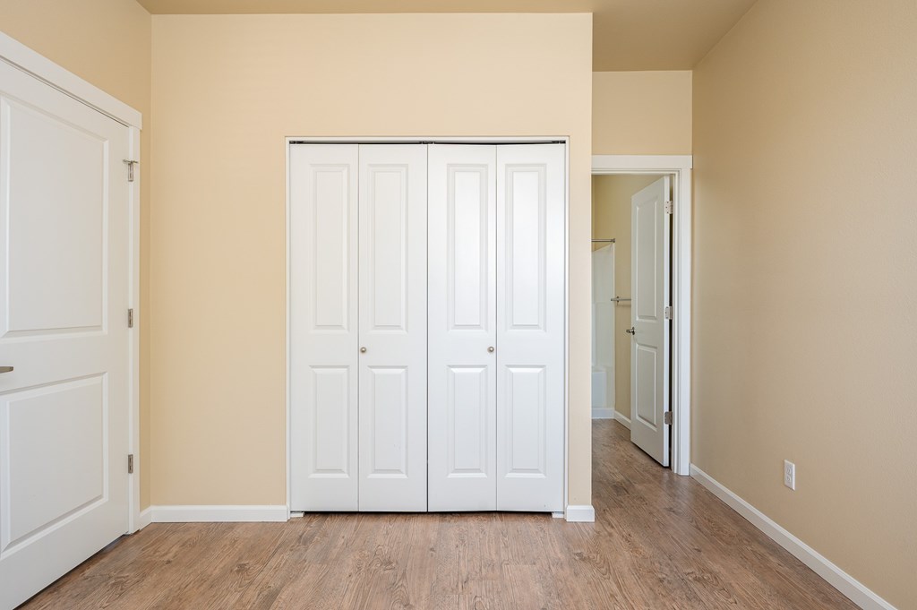 A room with a white door and a white cabinet.