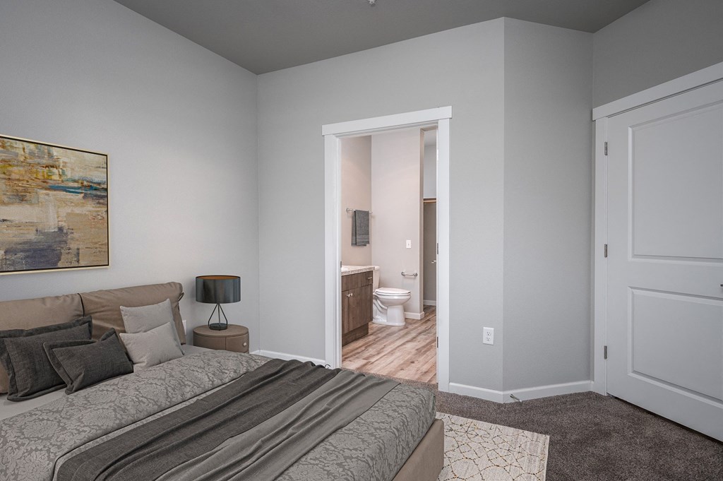 a bedroom with a bed and a doorway to a bathroom