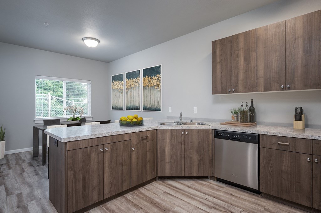 a kitchen with wooden cabinets and stainless steel appliances