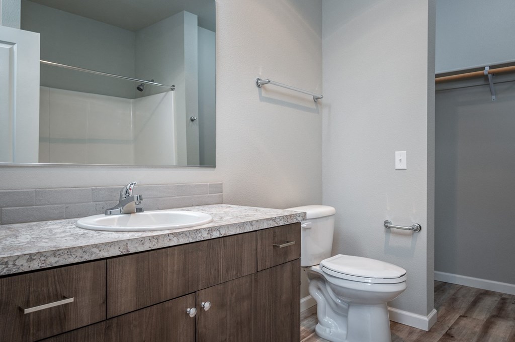 an empty bathroom with a toilet sink and mirror