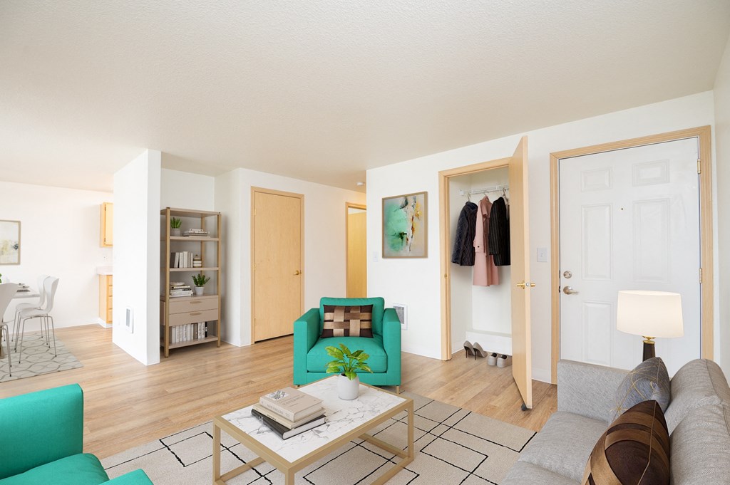 a living room with a couch and a coffee table    and a closet
