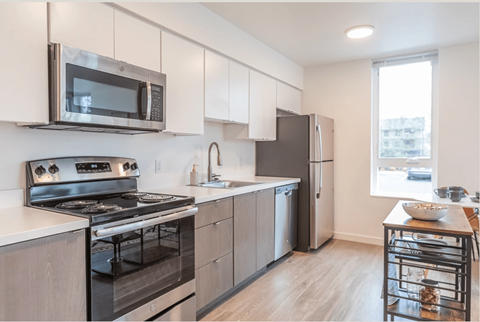 a kitchen with stainless steel appliances and white cabinets