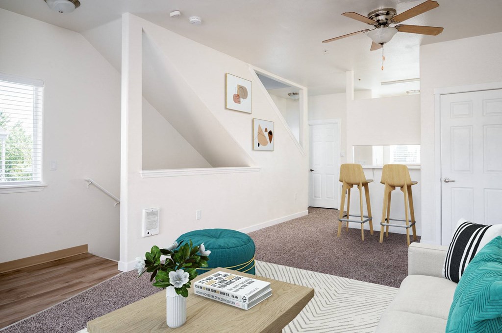 a living area with a couch coffee table and stools