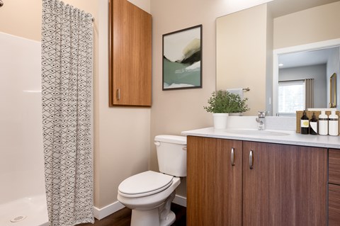 a bathroom with a toilet and a sink and a shower