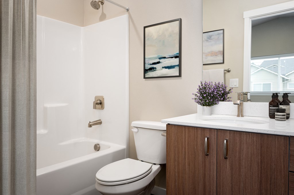 a bathroom with a toilet and a sink and a shower