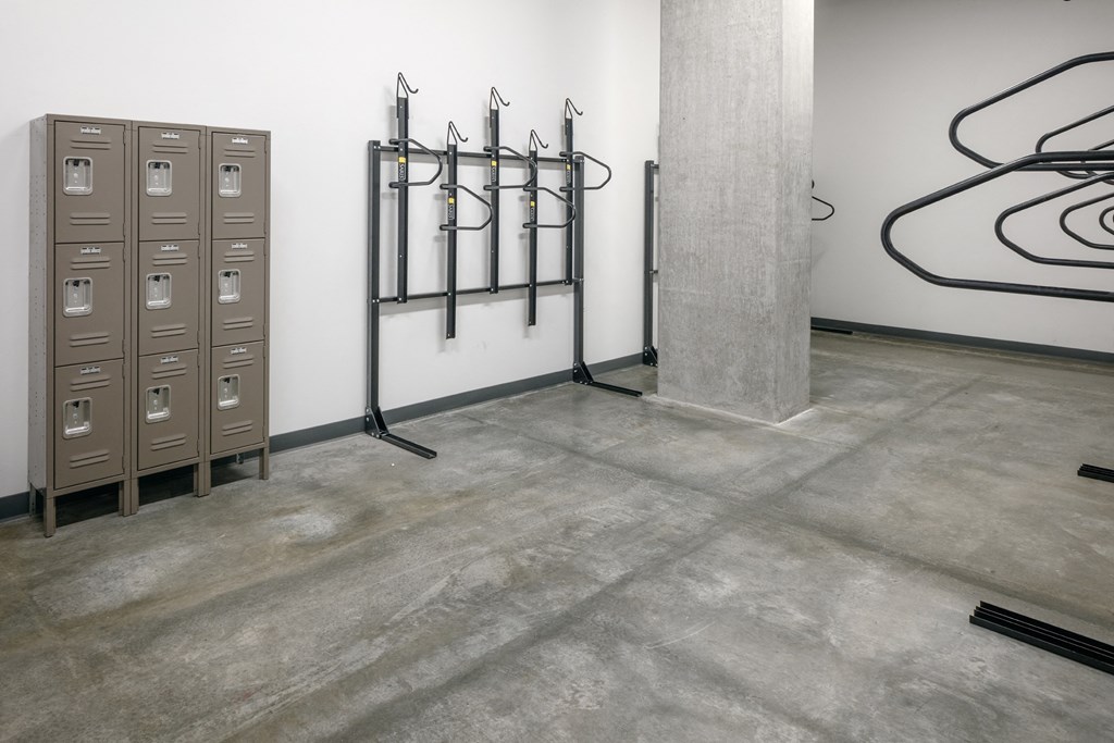 a room with a row of mailboxes and a wall with lines on the floor