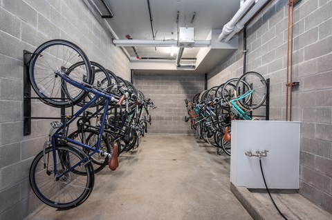 a row of bikes hanging on a wall in a room