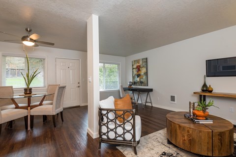 A living room with a white ceiling and a wooden coffee table.