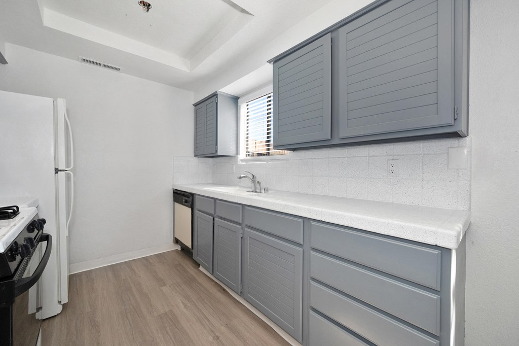 Townhouses for Rent in Tracy, CA - Townhomes at 201 - Kitchen with Grey Cabinetry, Speckled Countertops, and Wood-Style Flooring