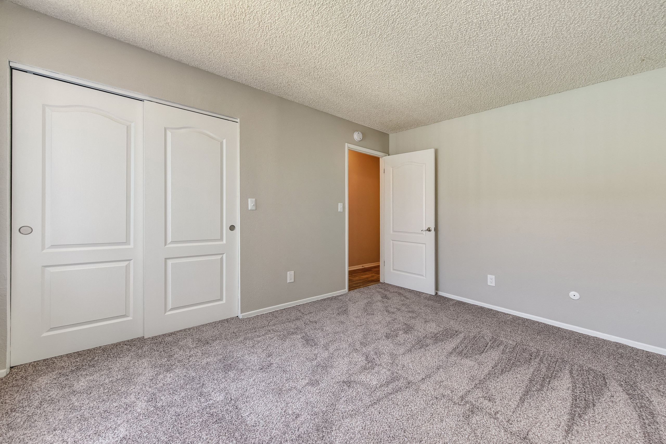 Spacious bedroom with wall to wall carpet and large closet